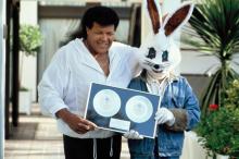 Chubby Checker and Jive Bunny accept sales awards in England in 1989.