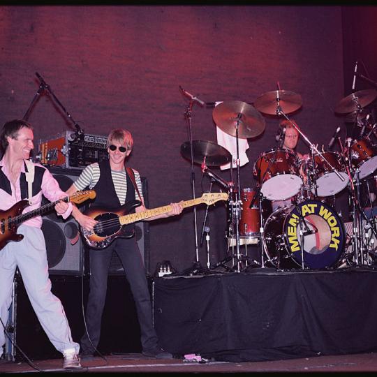 From left to right: Colin Hay plays guitar, John Rees plays bass guitar, and Jerry Speiser plays the drums at a Men at Work concert. (Photo by Geoff Butler/Corbis/VCG via Getty Images)