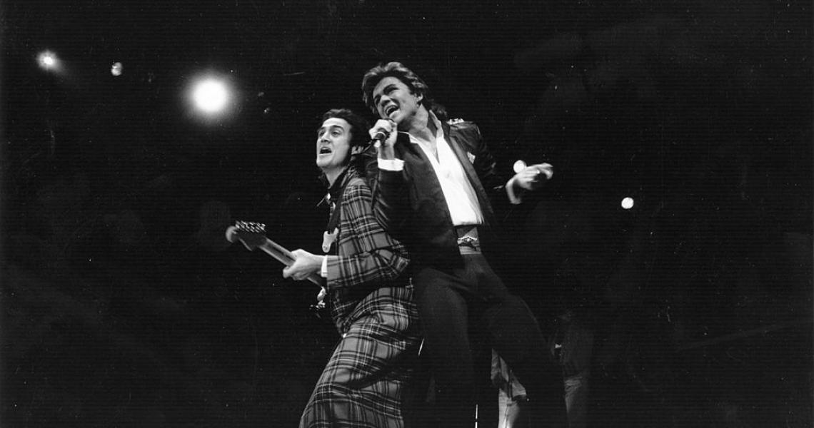 George Michael and Andrew Ridgeley of pop group Wham! during a live performance. Original Publication: People Disc - HL0194 (Photo by Express Newspapers/Getty Images)