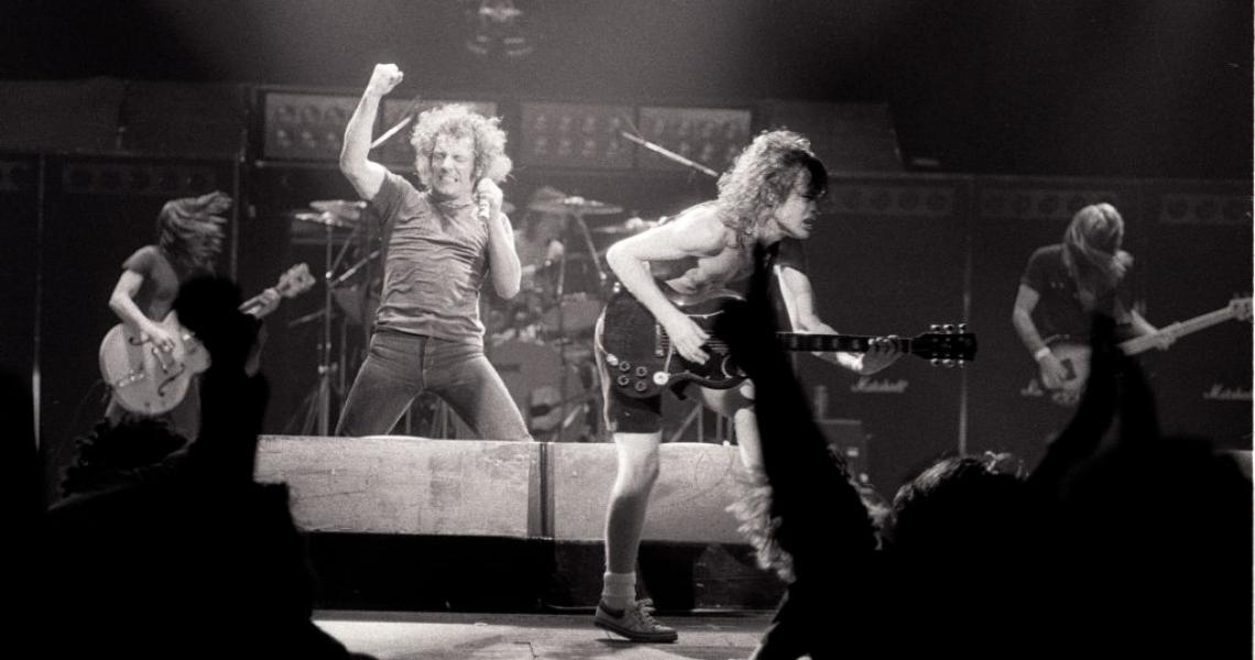 Heavy rock group AC/DC performing on tour in Europe, 1980. Left to right: rhythm guitarist Malcolm Young, singer Brian Johnson, drummer Phil Rudd, guitarist Angus Young and bassist Cliff Williams. (Photo by Michael Putland/Getty Images) 